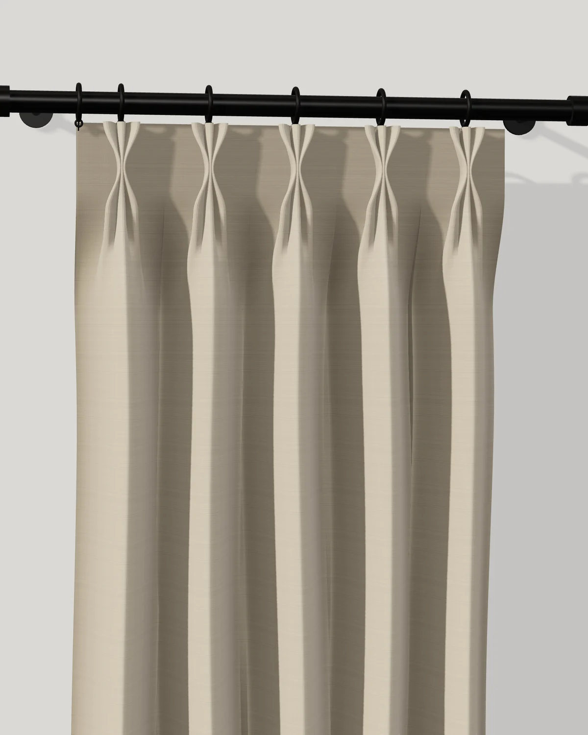 Linen pinch-pleat drapery on a black rod with rings. The three folds of each pleat are gathered a couple of inches below the top and fan open above and below the gather.