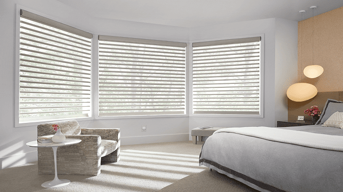 Motorized window shades installed on bedroom windows